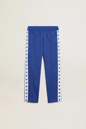 Bright blue joggers with white strip and contrasting bright blue stars