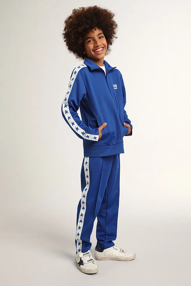 Bright blue joggers with white strip and contrasting bright blue stars