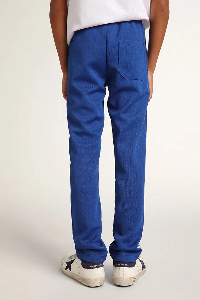 Bright blue joggers with white strip and contrasting bright blue stars