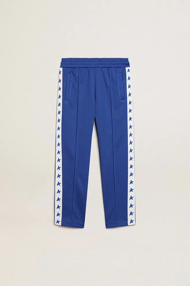 Bright blue joggers with white strip and contrasting bright blue stars