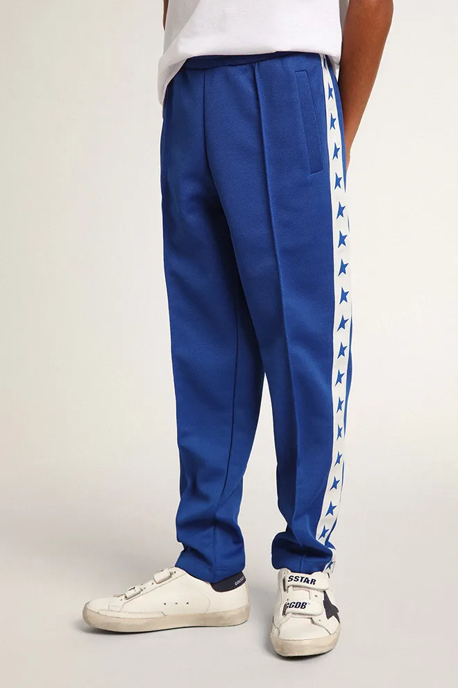 Bright blue joggers with white strip and contrasting bright blue stars